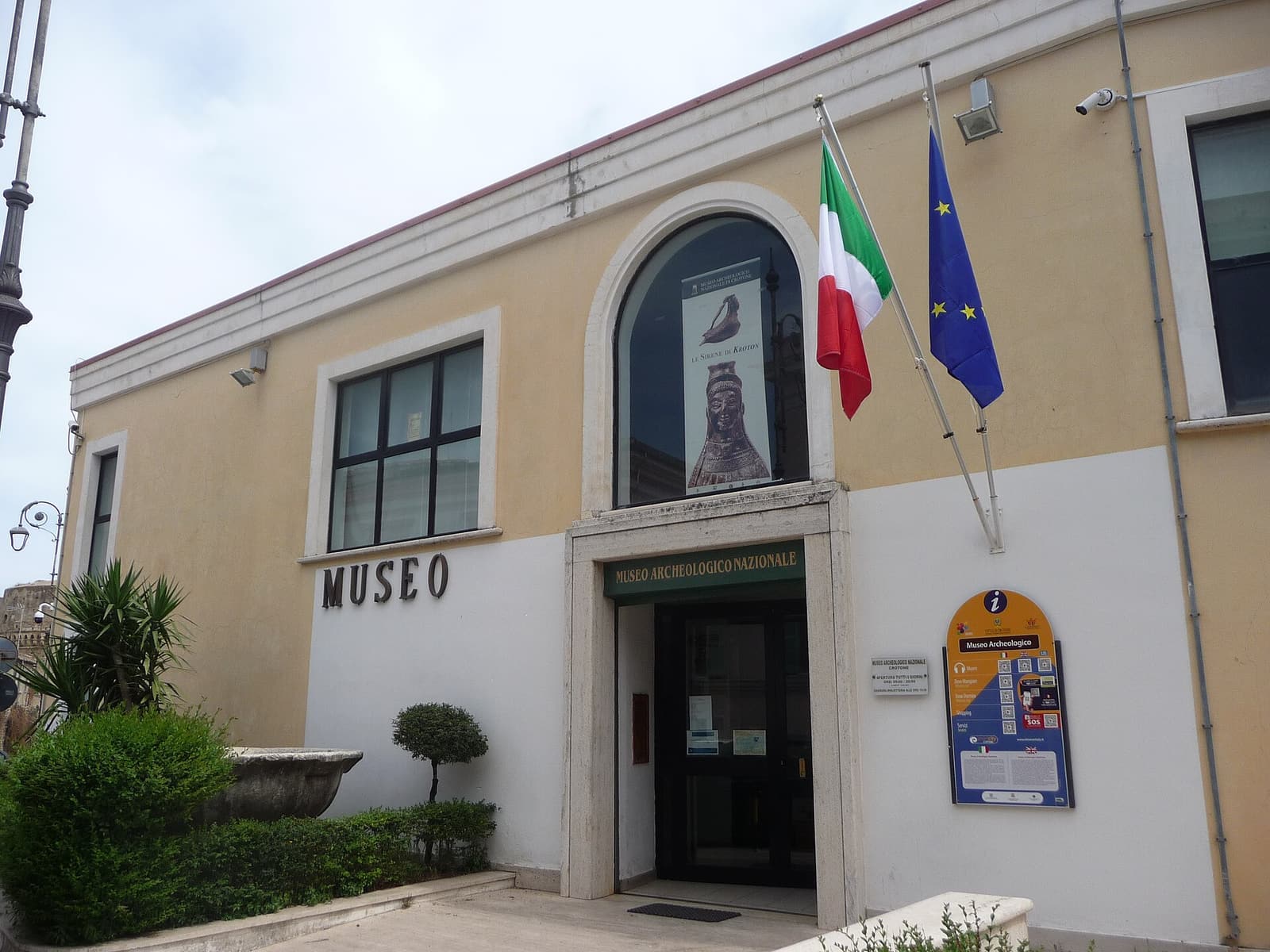 The entrance of the National Archaeological Museum of Crotone with Italian and European flags