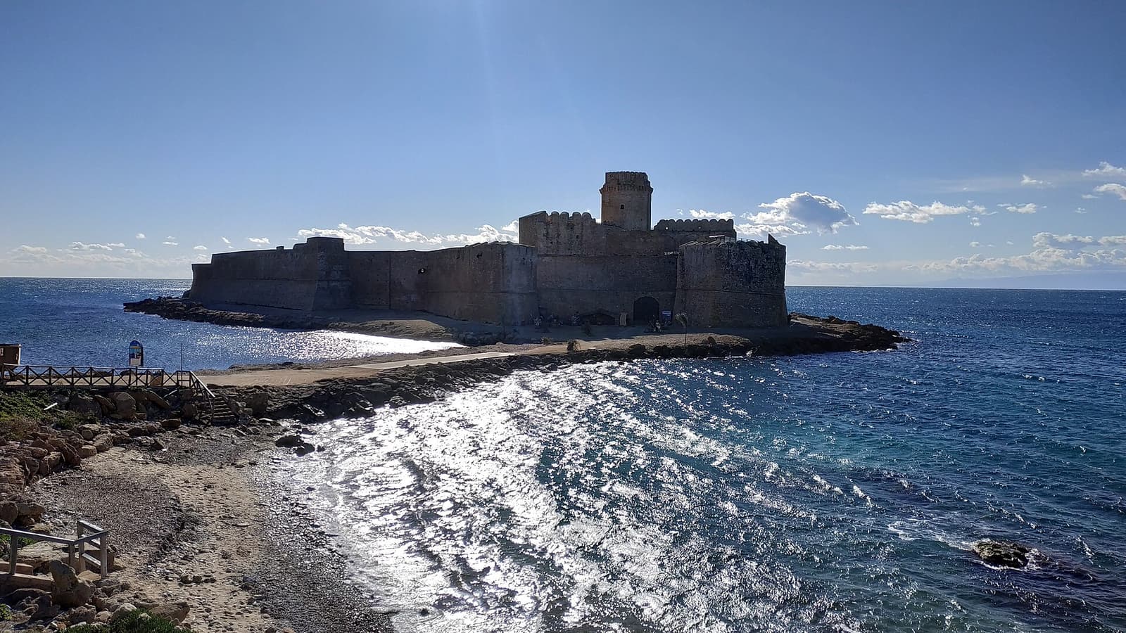 The fortress of Le Castella with sunlight on the sea